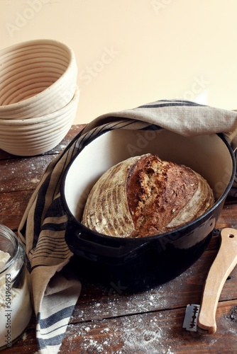 Homemade sourdough bread with seeds on the wooden background