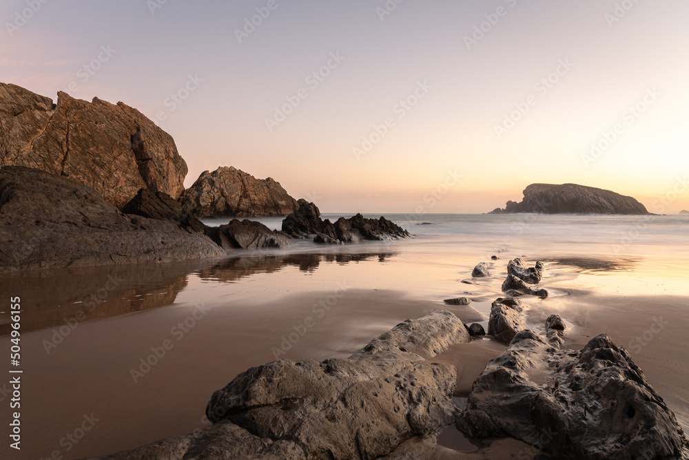 The spectacular rock formations on the shore of La Arnía beach at low tide at sunrise, Costa Quebrada, Liencres, Cantabria, Spain