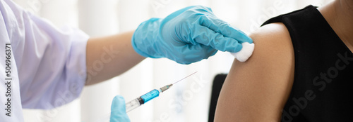 Doctor is vaccinating women with antibiotics or new antibodies to prevent the spread of the virus, Vaccination against communicable diseases concept.
