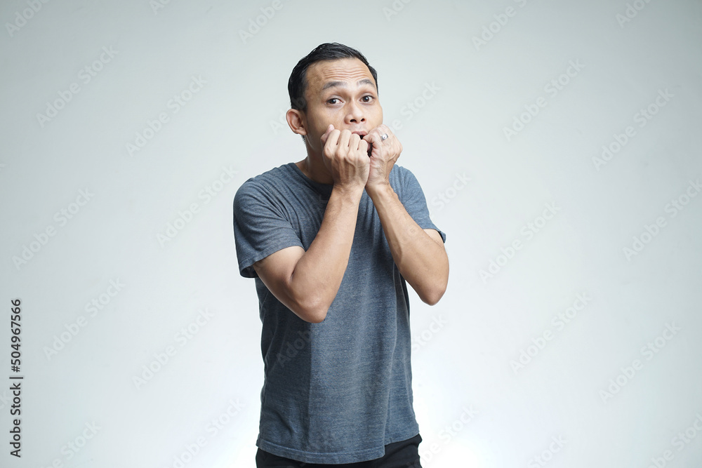 handsome asian man with shocked expression on isolated studio background handsome asian man with shocked expression on isolated studio background