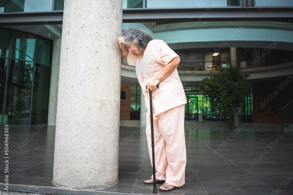 An Asian elderly woman standing and catch a pole Because she has a faint face Dizziness From pressure disease, to elderly patient and health concept.