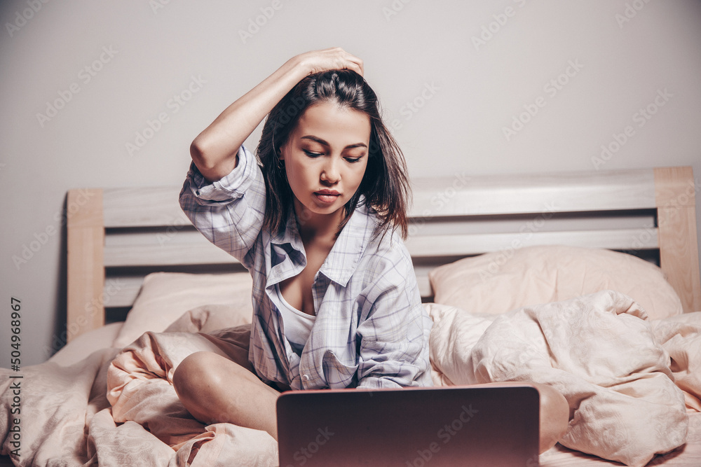 a young Asian webcam model girl is sitting in front of a laptop with her  legs spread. she communicates and shows her charms. low depth of  focus,artistic photo processing Photos | Adobe