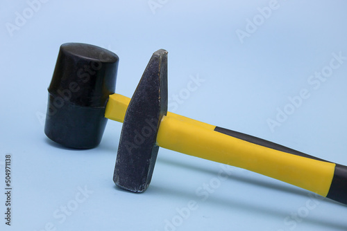 Photography hammer and mallet on a light blue background, the concept of construction, tools