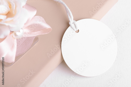 Round gift tag mockup with beige wedding favor on a white background, Wedding favor tag for souvenir, sign for message greeting, close up, element for design