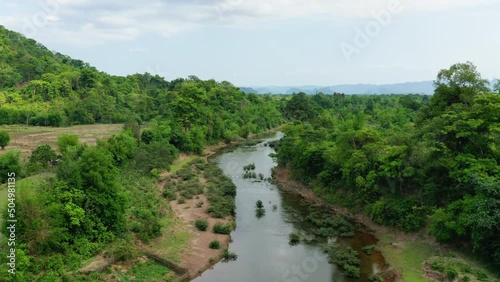 The Nam Theun river in the middle of tropical vegetation in Asia, Laos, Khammouane, towards Thakek, on a sunny day. photo