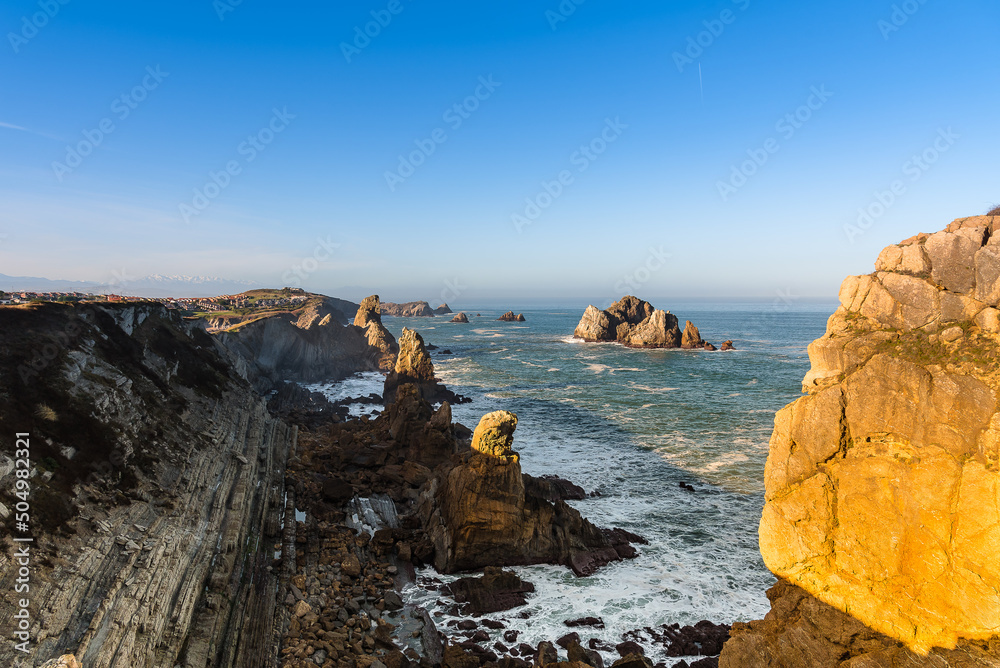 The spectacular rock formations on the shore of the Cantabrian coast at sunrise, Flysch at Costa Quebrada, Liencres, Cantabria, Spain