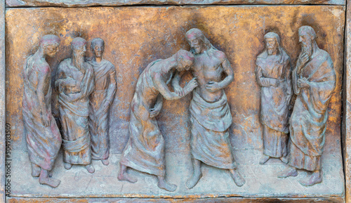 MONOPOLI, ITALY - MARCH 6, 2022: The bronze relief The Doubt of St. Thomas on the gate of church Chiesa di Sacro Cuore by Wolfgang Stempfele from year 2002.