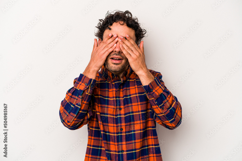 Young caucasian man isolated on white background afraid covering eyes with hands.