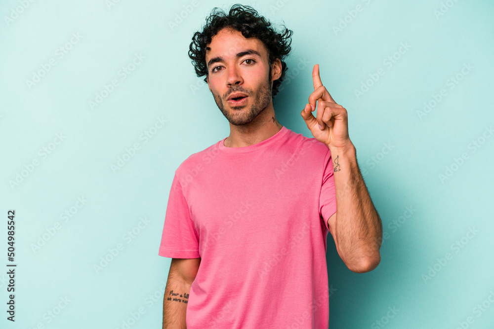 Young caucasian man isolated on white background pointing upside with opened mouth. Young caucasian man isolated on white background pointing upside with opened mouth.