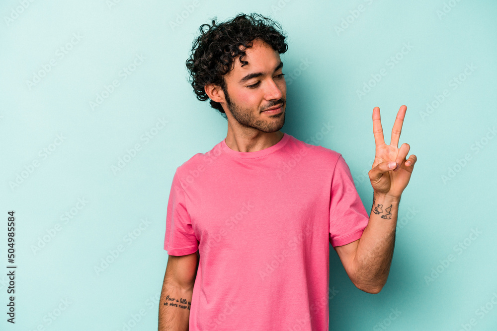 Young caucasian man isolated on white background joyful and carefree showing a peace symbol with fingers. Young caucasian man isolated on white background joyful and carefree showing a peace symbol with fingers.