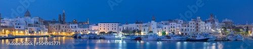 Fotografie Monopoli - The cityscape panorama with the harbor at dusk.
