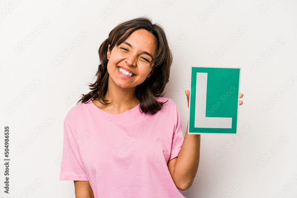 Young hispanic woman holding a beginner driver sign isolated on white background laughing and having fun.