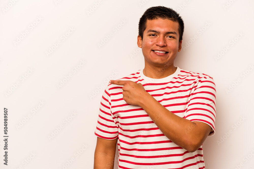 Young hispanic man isolated on white background smiling and pointing aside, showing something at blank space.