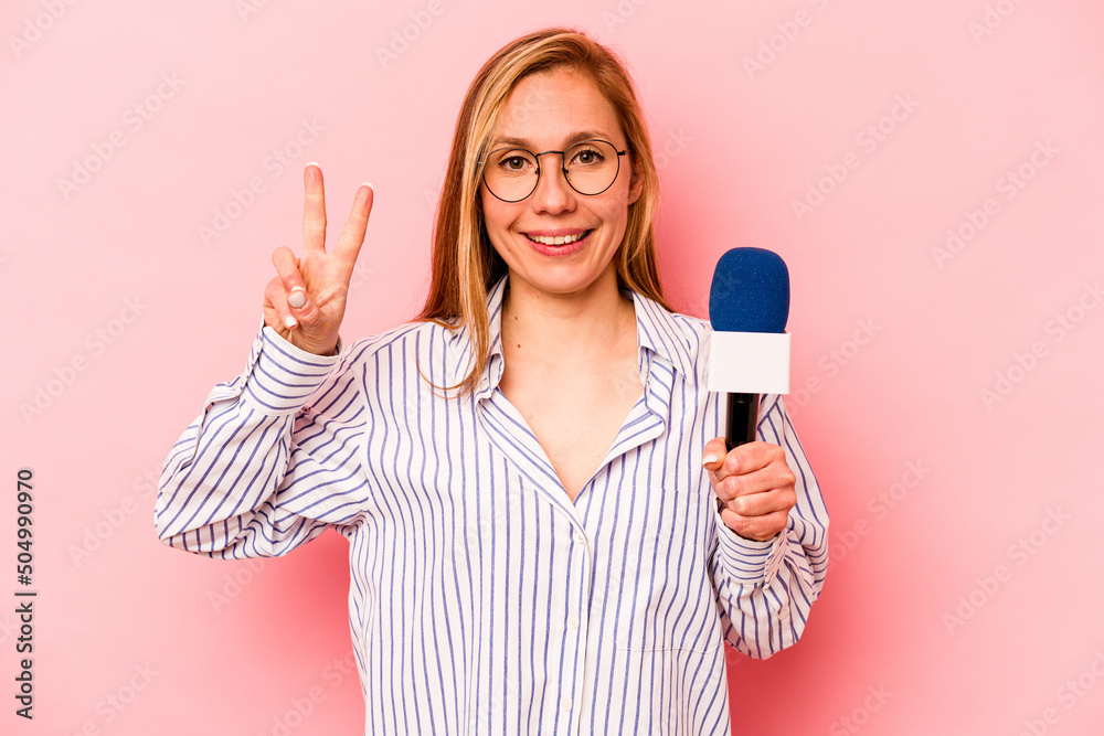 Young caucasian TV presenter woman isolated on pink background showing number two with fingers.