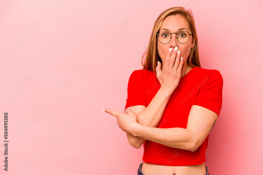 Young caucasian woman isolated on pink background pointing to the side Young caucasian woman isolated on pink background pointing to the side
