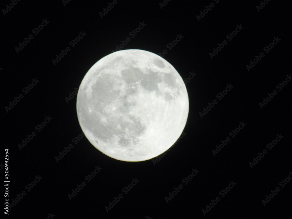 Genova, Italy -May 15, 2022: An amazing photography of the full moon over the city of Genova by night with a great clear sky in background and some stars Genova, Italy -May 15, 2022: An amazing photography of the full moon over the city of Genova by night with a great clear sky in background and some stars