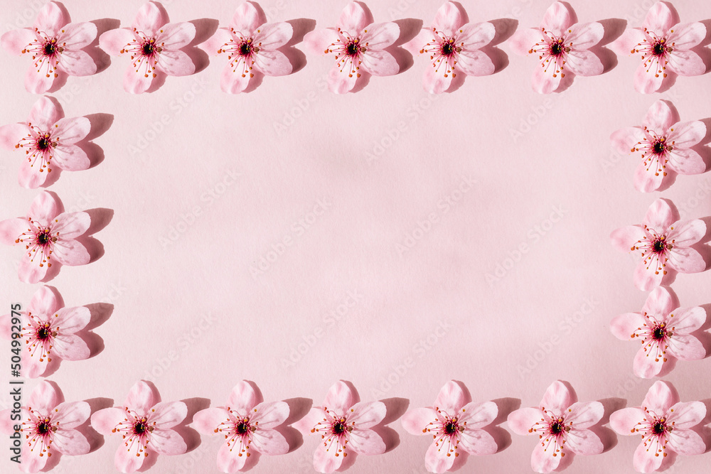 Flower pattern forming a frame to enter text. Flowers on pink background