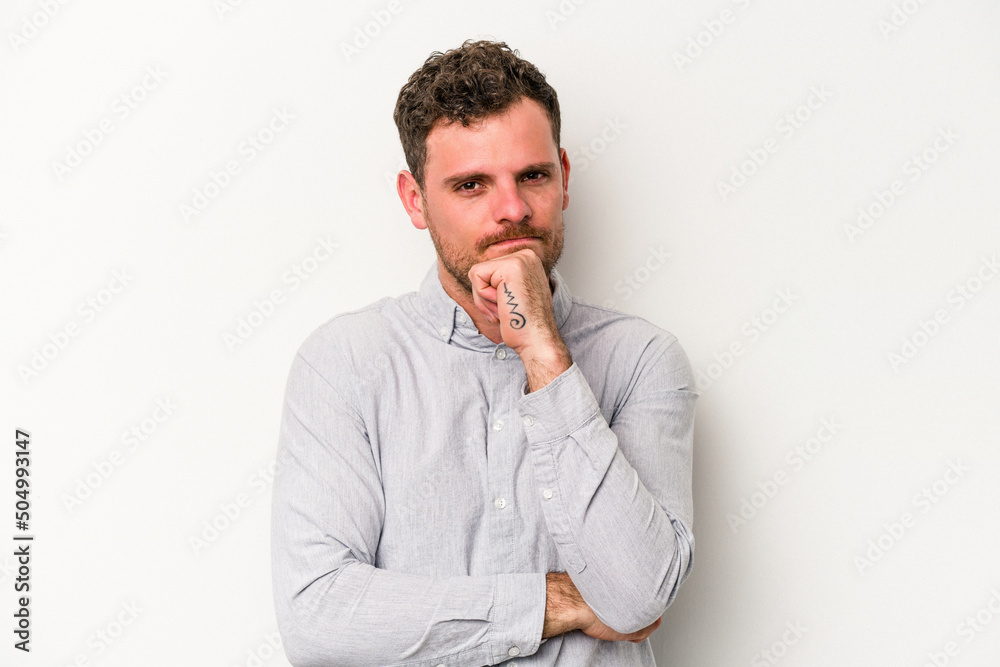 Young caucasian man isolated on white background suspicious, uncertain, examining you. Young caucasian man isolated on white background suspicious, uncertain, examining you.