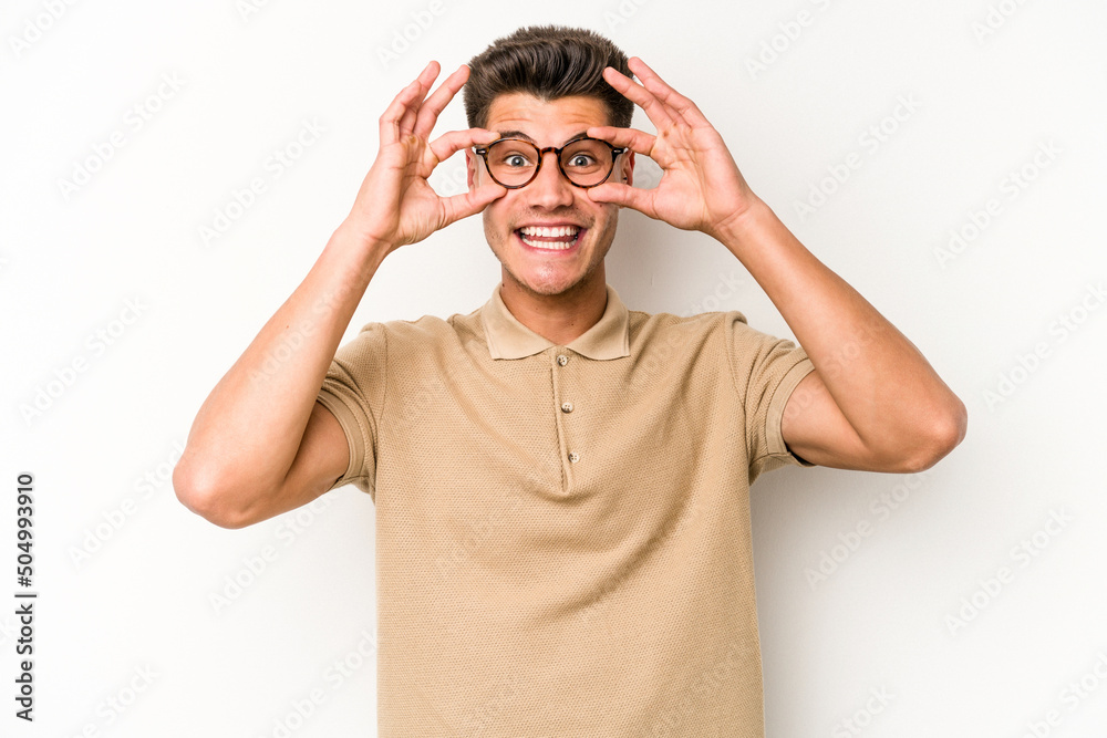 Young caucasian man isolated on white background keeping eyes opened to find a success opportunity. Young caucasian man isolated on white background keeping eyes opened to find a success opportunity.
