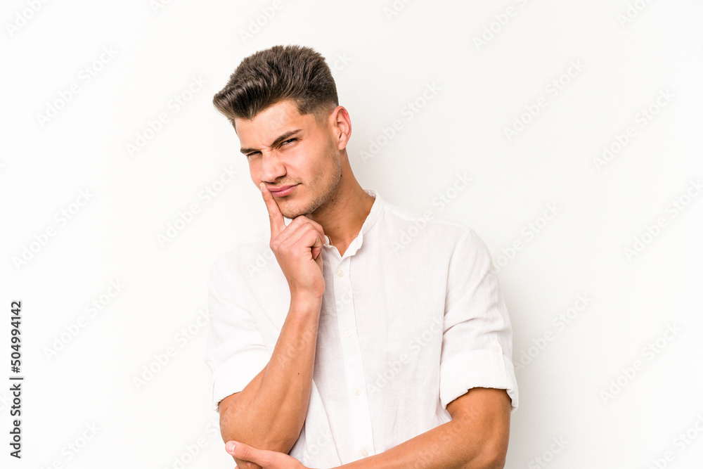 Young caucasian man isolated on white background contemplating, planning a strategy, thinking about the way of a business. Young caucasian man isolated on white background contemplating, planning a strategy, thinking about the way of a business.