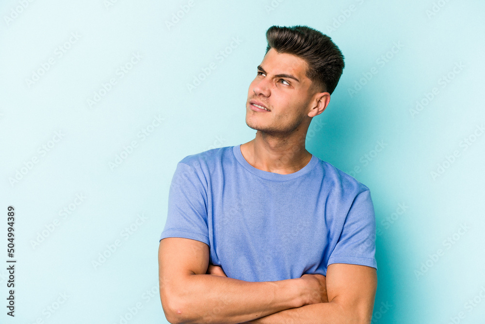Young caucasian man isolated on blue background dreaming of achieving goals and purposes Young caucasian man isolated on blue background dreaming of achieving goals and purposes