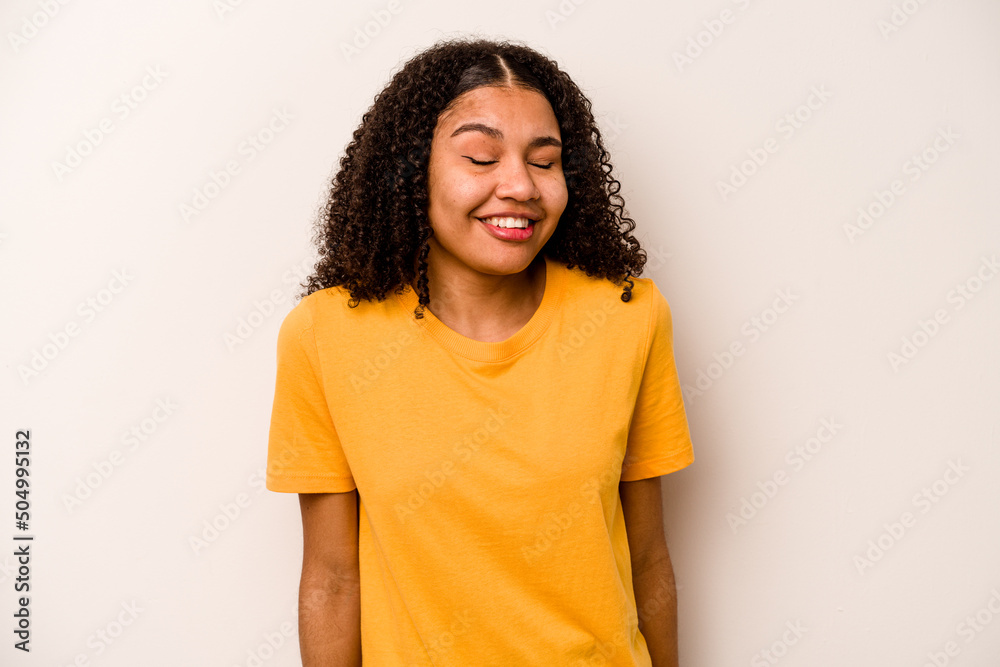 Young African American woman isolated on white background laughs and closes eyes, feels relaxed and happy. Young African American woman isolated on white background laughs and closes eyes, feels relaxed and happy.