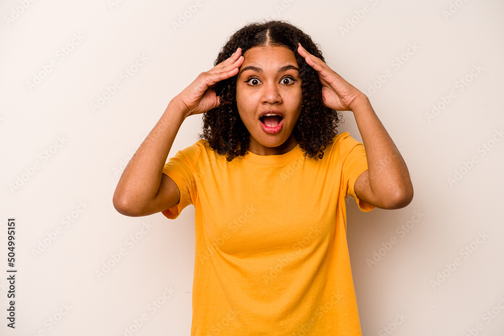 Young African American woman isolated on white background receiving a pleasant surprise, excited and raising hands. Young African American woman isolated on white background receiving a pleasant surprise, excited and raising hands.