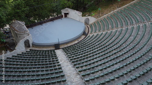 Aerial view of the stage and rows of empty plastic chairs for outdoor theater audiences
