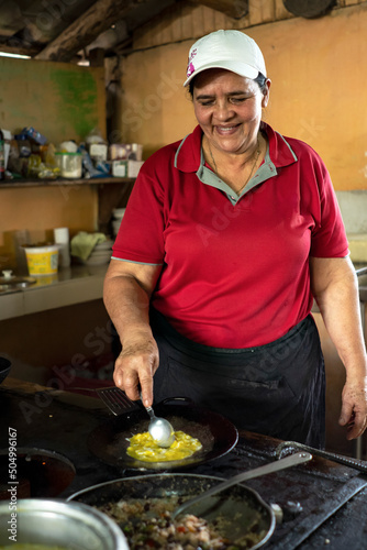 фотографія Woman cooks traditional Costa Rican lunch of Gallo Pinto
