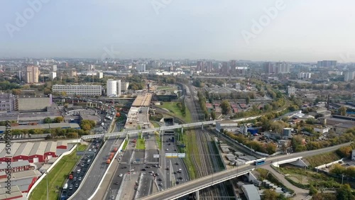 Timelapse of aerial top view of road junction in Moscow from above, automobile traffic and the old Ugreshskaya railway station in the Moscow industrial zone near the automobile ring highway. photo