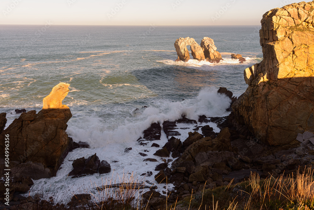 Beautiful seascape of the spectacular rock formations near the coast in the Cantabrian sea at sunrise, Urro del Manzano in Costa Quebrada, Liencres, Cantabria, Spain