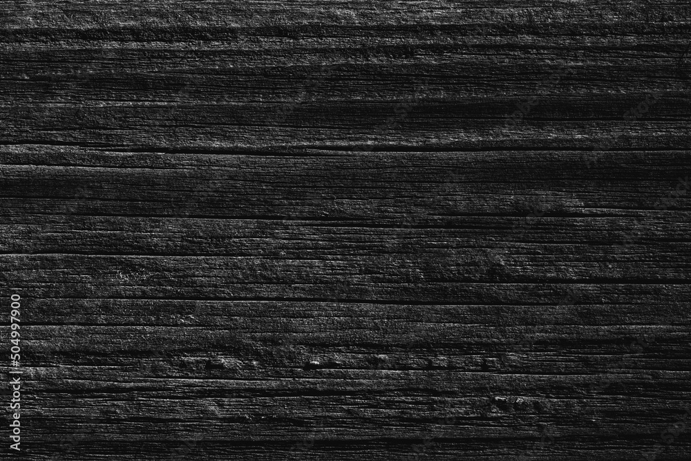 Black old wood background. Dark background from the texture of an old wooden board Black old wood background. Dark background from the texture of an old wooden board