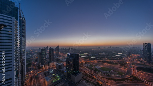 Aerial view of media city and al barsha heights district area night to day timelapse from Dubai marina.