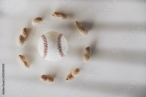 Baseball with peanuts for sport game concept on white background with copy space.