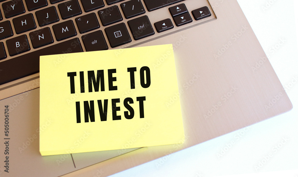 Εκτύπωση καμβά Notepad with the text TIME TO INVEST is on the laptop keyboard