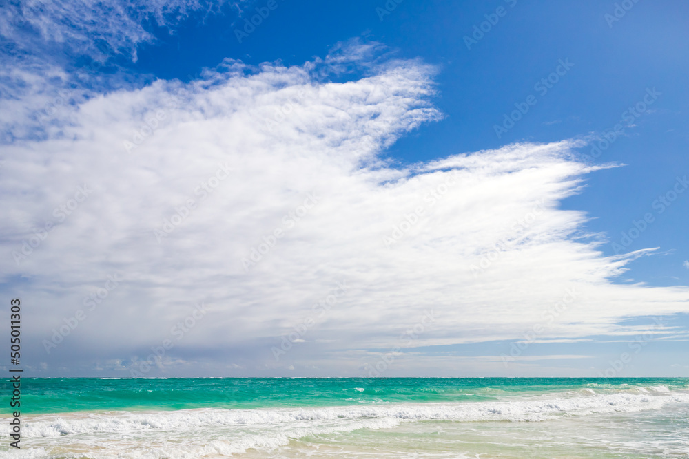 Sea shore is under blue sky with clouds on a sunny day, natural background