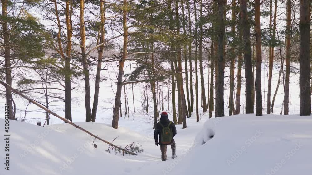 A lonely hermit tourist with a backpack got lost in the winter forest A lonely hermit tourist with a backpack got lost in the winter forest