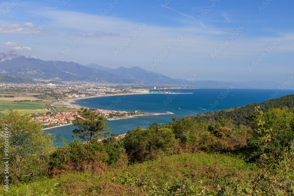 Top view of the Magra river's mouth on the border between Liguria and Tuscany in Italy. On the background are the mountain range of the Apuan Alps.