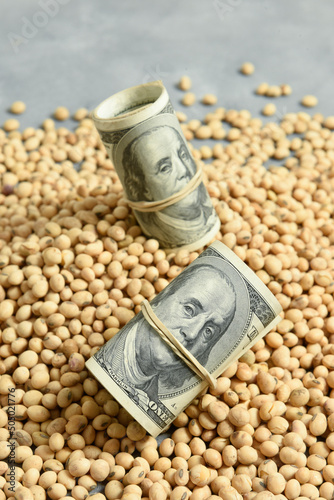 Dollars banknotes and coins and soy beans,oleaginous commoditi value concept. photo