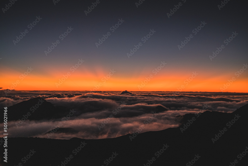 sunrise on top of volcano with clouds