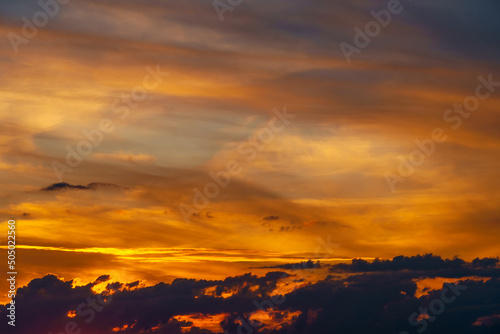 beautiful dramatic sunset sky  bright sunlight and dark silhouette of clouds as a background