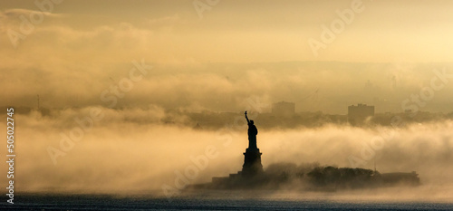 Statue of Liberty in the fog at sunset