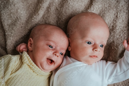Canvastavla Tiny newborn twins babies. boy and girl hugging each other.
