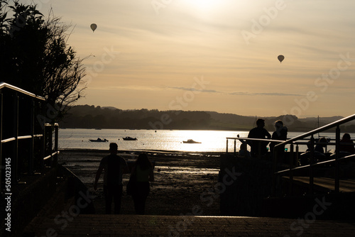 A group of hot air balloons flying over the River Exe as seen from Lympstone village, Devon, UK photo