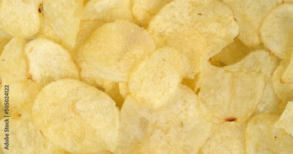4k video, craft fried golden potato chips, top view and rotating close up. fast food background 4k video, craft fried golden potato chips, top view and rotating close up. fast food background