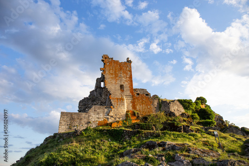 Remains of the Trevejo Castle in the foreground with the sky in the background photo