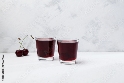 Ginjinha or Ginja - Portuguese liqueur made by infusing ginja berries (sour cherry, Prunus cerasus austera, Morello cherry) in alcohol (aguardente) and adding sugar. Selective focus, copy space photo