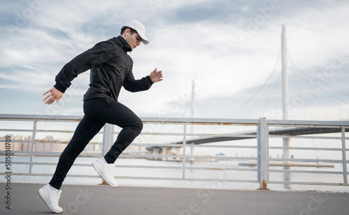 Male athlete runner training to run fast on the street in sportswear © muse studio