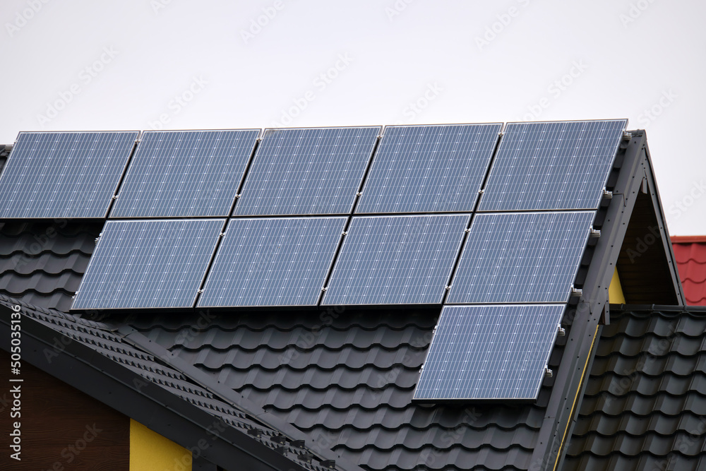 Private home roof covered with solar photovoltaic panels for generating of clean ecological electric energy in suburban rural town area. Concept of autonomous house Private home roof covered with solar photovoltaic panels for generating of clean ecological electric energy in suburban rural town area. Concept of autonomous house