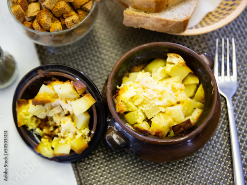 Appetizing roast with potatoes, served in a clay pot